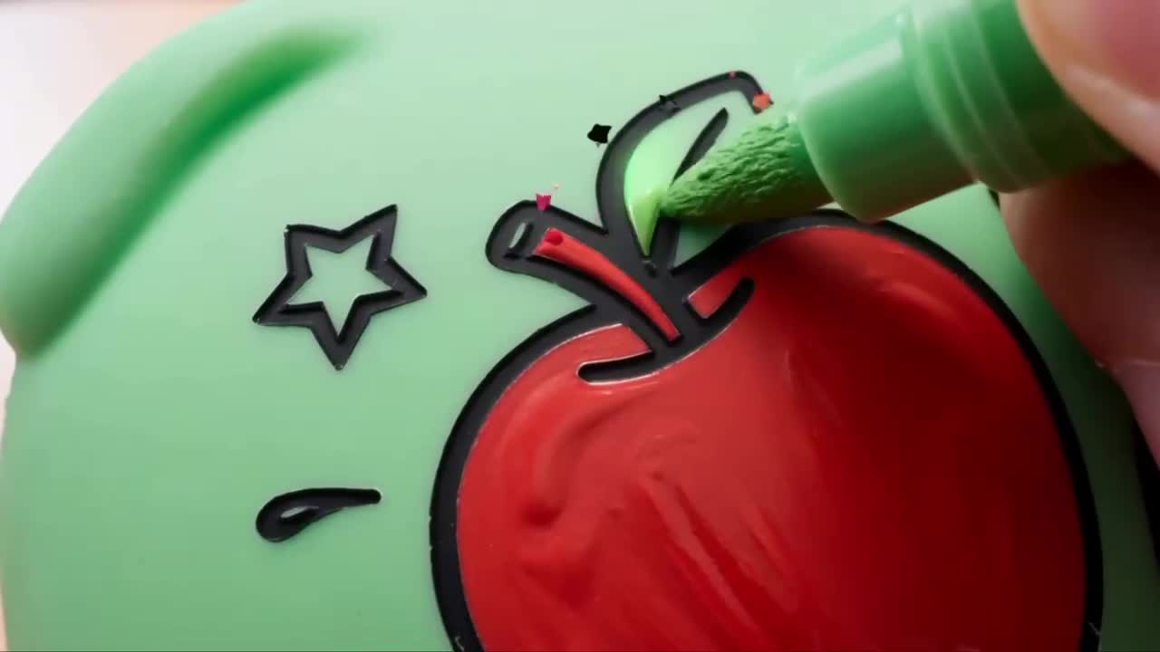 A marker colouring the apple pattern on a green Puffy Mallow